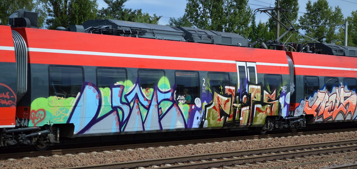 Graffiti an einem TALENT 2 der DB am 12.08.14 Bhf. Flughafen Berlin-Schönefeld.