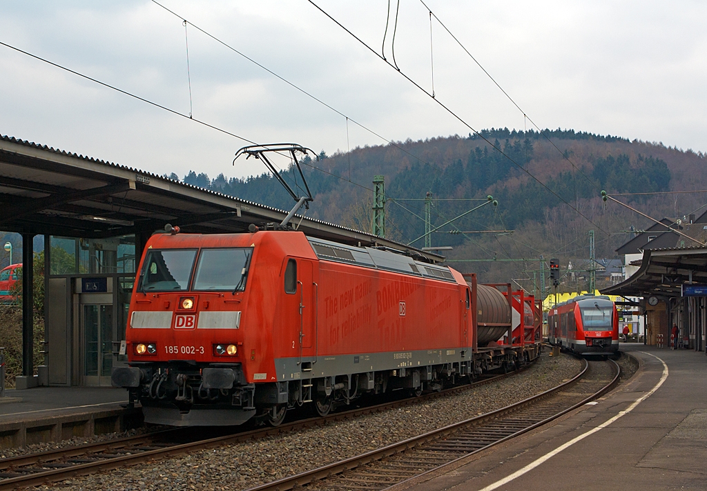 Die 185 002-3  (eine Bombardier TRAXX F140 AC 1) der DB Schenker Rail zieht am 28.03.2013 einen gemischten G�terzug durch den Bahnhof Betzdorf Sieg in Richtung K�ln.

Rechts auf Gleis 105 h�lt gerade 648 205 / 705 (ein Alstom Coradia LINT 41) der DreiL�nderBahn als RB 95 (Betzdorf-Siegen).