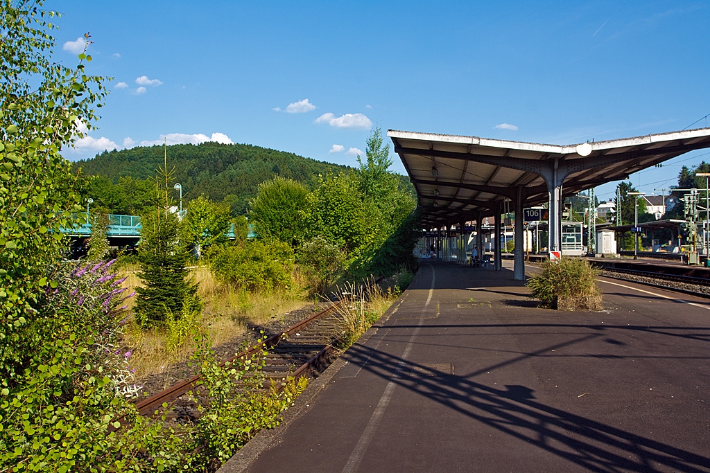Diese Bild wird es bald so nicht mehr geben - Der Bahnhof Betzdorf/Sieg am 22.07.2013. 
Blick vom Bahnsteig 106/107 in Richtung Osten. Im Zuge von dem Dieselnetz Eifel-Westerwald-Sieg wird bald das Gleis 107 wieder reaktiviert, dann werden die B�umchen und Str�ucher wohl wieder weichen m�sse.

Betzdorf/Sieg ist ein Keilbahnhof an der KBS 460 (Siegstrecke), aus dieser Blickrichtung zweit nach rechts die KBS 462 (Hellertalbahn) ab, von der bei Alsdorf wiederum die KBS 463 (Daadetalbahn) abzweigt.

Als gro�e Ver�nderung sind ab August 2015:
• Verl�ngerung der RB 28 (z.Z. Limburg/Lahn – Altenkirchen/Ww – Au/Sieg) �ber Betzdorf hinaus bis nach Siegen und bei einzelnen Fahrten nach/von    Kreuztal.
• Verl�ngerung der RB 93  Rothaarbahn  (z.Z. Bad Berleburg - Kreuztal – Siegen), �ber Siegen hinaus bis nach Betzdorf.
• Durch diese beiden Ma�nahmen Schaffung eines 30-Minuten-Taktes im RB-Angebot zwischen Betzdorf und Siegen an Werktagen.
• Verbesserte Anschlussverbindungen der RB 96  Hellertalbahn  Betzdorf – Herdorf – Haiger – Dillenburg  in Betzdorf an den RE 9 „Rhein-Sieg-Express“ und in Dillenburg an den Hessen-Express.
• Verbesserte Anbindung der Gemeinde Burbach an der KBS 462 (Hellertalbahn) durch die RB 96  Hellertalbahn .
• Verbesserte Reisekette aus dem Westerwald nach K�ln mit Anschluss in Au (Sieg) an den RE 9.
• Den Zuschlag f�r diese Los 2 von dem Dieselnetz EWS hat die HLB Hessische Landesbahn bekommen, hierf�r werden mit der Betriebsaufnahme modernisierte Dieseltriebz�ge (TALENT / LINT bzw. LINT / GTW) und auch einige neue Dieseltriebwagen (LINT) zum Einsatz kommen.

Ich bin darauf gespannt, und freue mich erst mal darauf. Was mich am meisten freut ist die Tatsache, dass der �NPV auf der Schiene hier wohl wieder etwas ausgebaut wird. 

Wer Triebwagen mag f�r den wird Betzdorf/Sieg wohl wieder dann ein Eldorado werden.