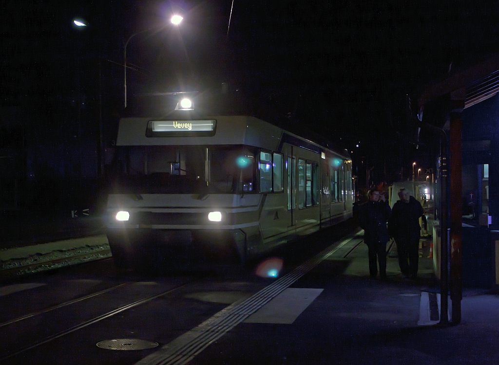 Ein Schienen-Wohnwagen bei Nacht: Am 25.02.2012 im Bahnhof Blonay der meterspurigen Triebwagen Be 2/6 - 7003 (Stadler Elektrischer Niederflur-Doppelgelenk-Leichttriebwagen Typ GTW 2/6) der MVR (Transports Montreux–Vevey–Riviera) ex CEV (Chemins de fer �lectriques Veveysans), steht zur Abfahrt nach Vevey bereit.