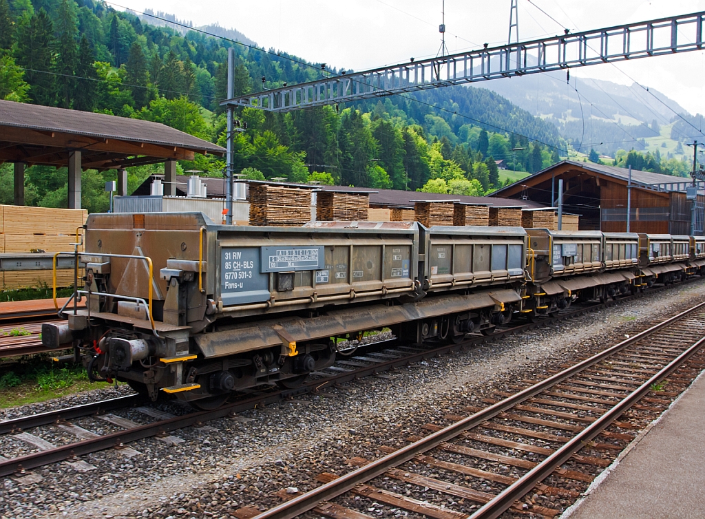 Vierachsige offene Kippwagen mit Schwerkraftentladung der Gattung Fans-u (Wagen-Nr. 6770 501-3 und weitere) BLS AG abgestellt am 28.05.2012 bei Erlenbach im Simmental, aufgenommen aus fahrendem Zug. 
Die beiden Kippkasten (Ladegr��e 4950 x 2540 mm) sind jeweils zu den L�ngsseiten elektro-hydraulisch beidseitig kippbar.  Diese Wagen sind speziell geeignet f�r unempfindliche Sch�ttg�ter wie Schotter und Aushubmaterial, das max. Ladegesamtgewicht ist 61t.