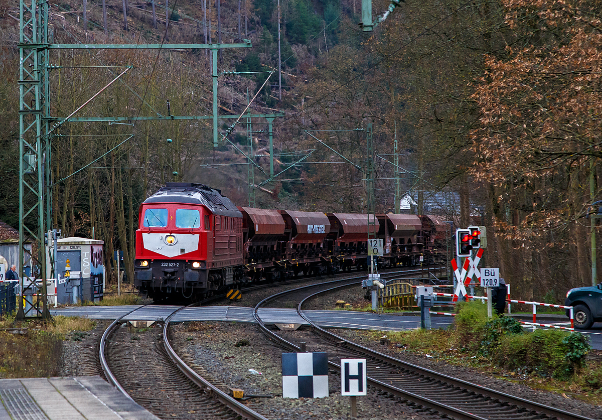 Die „Ludmilla“ 233 527-2 (92 80 1233 527-2 D-WFL) der WFL - Wedler Franz Logistik GmbH & Co. KG (Potsdam) fährt am 03.12.2021 mit einem Schotterzug durch den Bahnhof Kirchen/Sieg in Richtung Siegen.

Die Ludmilla bzw. V 300 wurde 1977 von LTS (Luhanskyj Teplowosobudiwnyj Sawod , auch bekannt als Lokomotivfabrik Lugansk (ehemals Woroschilowgrad) unter der Fabriknummer 0762 gebaut und als DR 132 527-3 an die Deutsche Reichsbahn (DR) geliefert. Zum 01.01.1992 erfolgte die Umzeichnung in DR 233 527-2 und zum 01.01.1994 dann in DB 233 527-2. Im Jahre 2015 wurde sie bei der DB Cargo ausgemustert und 2018 an die WFL verkauft.

Die Lokomotiven dieser Baureihe sind für den mittleren und schweren Streckendienst geeignet. Die Leistung vom wird von einem Kolomna 5D49 direkteinspritzenden 16-Zylinder-Viertakt-Dieselmotor mit Abgasturbolader und Ladeluftkühlung, 4 Ventile pro Zylinder, sowie mit Zylindergruppenabschaltung vom bereitgestellt. Die Höchstgeschwindigkeit beträgt 120 km/h. 

Weitere TECHNISCHE DATEN der BR 234:
Hersteller: Lokomotivfabrik „Oktoberrevolution“Lugansk
Spurweite: 1435 mm (Normalspur)
Achsformel: Co’Co’
Länge über Puffer: 20.820 mm
Drehzapfenabstand: 11.980 mm
Achsstand im Drehgestell: 2 x 1.850 mm (3.700 mm)
Breite des Lokkastens: 2.950 mm
Höhe über Schienenoberkannte: 4.590 über SOK
Dienstgewicht: 124 t
Radsatzfahrmasse: 20,6 t
Anfahrzugkraft: 294 kN
Dauerzugkraft: 194 kN
Höchstgeschwindigkeit: 120 km/h
Treibraddurchmesser: 1.050 mm (neu) / 952 mm (abgefahren)

Motorart: direkteinspritzenden V-16-Zylinder-Viertakt-Dieselmotor mit Abgasturbolader und Ladeluftkühlung, 4 Ventile pro Zylinder, mit Zylindergruppenabschaltung
Motorentyp: Kolomna 5D49
Motorhubraum: 220,9 l
Ladeluftdruck: 1,3 bar
Einspritzbeginndruck: 320 bar
Max. Verbrennungsdruck: 115 bar
Motorleistung: 2.230 kW (3.000 PS)

Leistungsübertragung: elektrisch
Traktionsgeneratortyp: GS-501A
Traktionsgeneratorleistung: 2.190kW
Traktionsleistung: 1.830 kW (6 x 305 kW)
Anzahl der Fahrmotoren: 6 vom Typ ED 118
Tankinhalt: max. 6.000 l (Grenzwertüberwacht bei 5.400 l)
Bremse: KE-GPR + E mZ