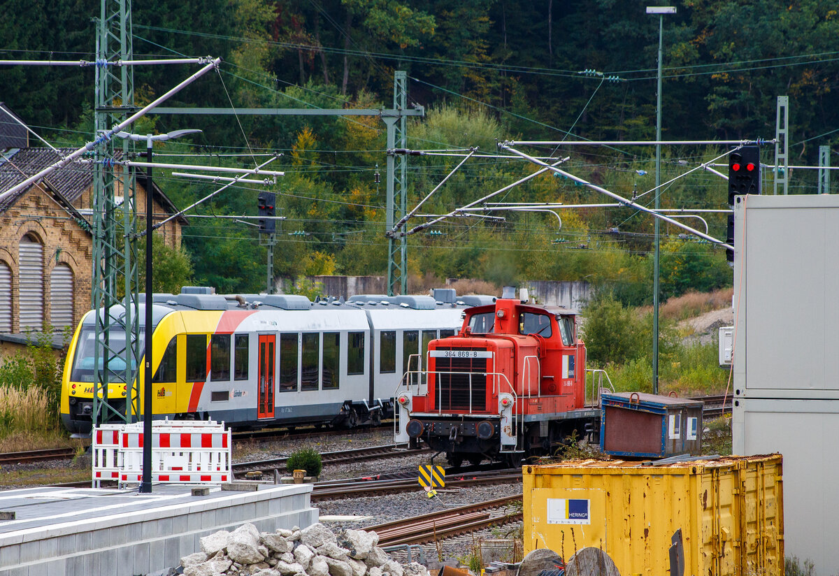 Die an die HERING Bahnbau GmbH (Burbach-Holzhausen) vermietete 364 869-8 (98 80 3364 869-8 D-BEG), eine V 60 - leichte Ausführung mit Funkfernsteuerung der BEG - Brohltal-Schmalspureisenbahn Betriebsgesellschaft mbH, ex DB 364 869-8, ex DB 360 869-2, ex DB 260 869-3 sowie ex DB V60 869, fährt am 03 Oktober 2025 auf Triebfahrzeugfahrt (solo) durch Betzdorf/Sieg in Richtung Köln.

Die V 60 der leichten Ausführung wurde 1960 von Krauss-Maffei in München-Allach unter der Fabriknummer 18631 gebaut und als DB V 60 869 an die Deutsche Bundesbahn geliefert. 1968 erfolgte die Umzeichnung in DB 260 869-3, Zum 01.10.1987 wurde sie, wie alle V 60, zur Kleinlok und somit zur DB 360 869-2. Im Jahr 1991 erfolgte der Umbau bzw. die Ausrüstung mit Funkfernsteuerung und sie wurde dadurch zur DB 364 869-8. Die Ausmusterung bei der DB erfolgte 2008 und sie wurde 2009 an die Pfalzbahn Eisenbahnbetriebsgesellschaft mbH in Frankenthal verkauft, wo sie die NVR-Nummer 98 80 3364 869-8 D-PBE trug. Seit 2024 ist sie nun bei der BEG und seit Februar 2025 an die HERING Bahnbau GmbH vermietet.

Die V60-Familie:
Die Deutsche Bundesbahn hatte nach ihrer Gründung einen Mangel an kleinen Rangierlokomotiven. Daher wurde ab 1951 eine Dieselrangierlok entwickelt, an deren Bau und Entwicklung fast alle namhaften Lokomotivfabriken beteiligt waren. Die neue Baureihe wurde zunächst als V 60 bezeichnet. Noch 1955 wurden die ersten 275 Serienloks in Auftrag gegeben, sie hatten den Motor GTO 6 von Maybach und das Dreiganggetriebe L 37 zUB von Voith.

Durch einen verstärkten Rahmen erhielten einige der Lokomotiven ein höheres Reibungsgewicht von 53 Tonnen (somit schwere Ausführung, spätere BR 261/361) statt 48,3–49,5 Tonnen. Zusätzlich konnten bei diesen Loks für den schweren Dienst noch bis zu sechs Tonnen Ballast mitgeführt werden, die Baureihenbezeichnung blieb jedoch bei V 60. Insgesamt wurden 942 Lokomotiven der leichten und schweren Ausführung zusammengenommen geliefert. Anhand der Ordnungsnummer war eine Unterscheidung der leichten und der schweren Ausführung nicht möglich, erst zum 1. Januar 1968 wurde mit der Einführung der computerlesbaren Nummern für die DB-Lokomotiven die Baureihe V 60 in die 618 Fahrzeuge umfassende Baureihe 260 (leichte Ausführung) und 322 Fahrzeuge umfassende Baureihe 261 (schwere Ausführung) aufgeteilt. Bei den vierstelligen Ordnungsnummern entfiel die führende Tausenderstelle.

Die V60 wurden 1987 als Kleinloks eingestuft und trug seitdem die Baureihenbezeichnung 360 (leichte Ausf.) bzw. 361 (schwere Ausf.). Die Einstufung als Kleinlok sparte Personalkosten, da die Bundesbahn nun keine „Lokführer“ mehr einsetzen musste, sondern „Kleinlokbediener“, deren Ausbildung günstiger war. Durch die Umstellung der Führerschein-Systematik hat die Einstufung als Kleinlok heute nur noch deklaratorische Bedeutung, die V 60 würde nach wie vor die technischen Anforderungen an „großen“ Lokomotiven gemäß EBO erfüllen. Der Einbau von Funkfernsteuerungen erlaubte Einmann-Rangierfahrten, die fernsteuerbaren Modelle wurden Baureihe 364 (leichte Bauart) bzw. 365 (schwere Bauart).

TECHNISCHE DATEN:
Spurweite: 1.435 mm (Normalspur)
Achsanordnung:  C
Länge über Puffer: 10.450 mm
Höhe: 4.540 mm
Breite: 3.100 mm
Gesamtradstand: 4.400 mm
Dienstgewicht: 48,0 t
Radsatzlast max: 16 t
Nennleistung: 465 kW (632 PS) bei 1.800 U/min
Anfahrzugkraft: 117,6 kN
Höchstgeschwindigkeit: 60 km/h (Streckengang) / 30 km/h (Rangiergang)
Kraftübertragung: hydraulisch
Antriebsart:  Blindwelle-Stangen
Kleinster bef. Halbmesser: R 100 m

Hier mal eine Übersicht der Baureihen-Bezeichnung (V60):
BR V 60 ursprüngliche Bezeichnung ab Ablieferung bis 1.1.68
BR 260 leichte Ausführung bis Okt. 1987
BR 261 schwere Ausführung bis Okt. 1987
BR 360 leichte Ausführung
BR 361 schwere Ausführung
BR 362 modernisierte leichte Ausführung mit Funk und neuen CAT 3412E DI-TTA Motor
BR 363 modernisierte schwere Ausführung mit Funk und neuen CAT 3412E DI-TTA Motor
BR 364 leichte Ausführung mit Funkfernsteuerung
BR 365 schwere Ausführung mit Funkfernsteuerung
