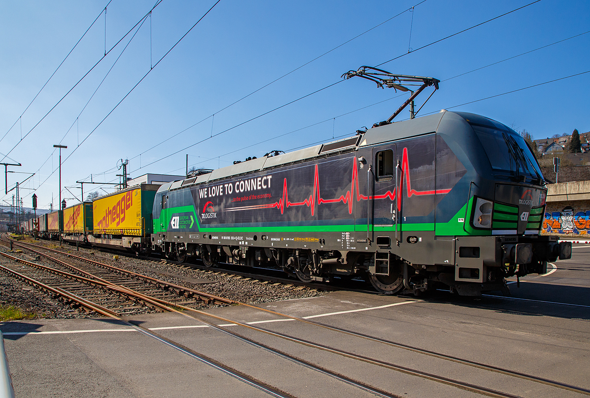 Die an die TX Logistik AG (Bad Honnef) vermietete Siemens Vectron AC 193 252 „We love to Connect“ (91 80 6193 266-4 D-ELOC) der European Locomotive Leasing, fährt am 25.03.2021 mit einem KLV-Zug über die Siegstrecke (KBS 460) durch Niederschelden in Richtung Siegen.

Die Siemens Vectron AC  wurde 2016 von Siemens Mobilitiy in München-Allach unter der Fabriknummer 22026 gebaut. Diese Vectron Lokomotive ist als AC – Lokomotive (Wechselstrom-Variante) mit 6.400 kW konzipiert und zugelassen für Deutschland, Österreich und Ungarn (D/A/H).