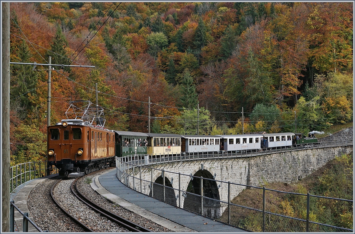 Die Bernina Bahn Ge 4/4 81 der Blonay Chamby Bahn ist mit einem langen Reisezug auf dem Weg nach Vevey und überquert nun den Baie de Clarens Viadukt. (Die am Schluss mitlaufende G 3/3 N° 5 verkehrt mit zwei Reisezugwagen nur bis Blonay) 

27. Okt. 2019