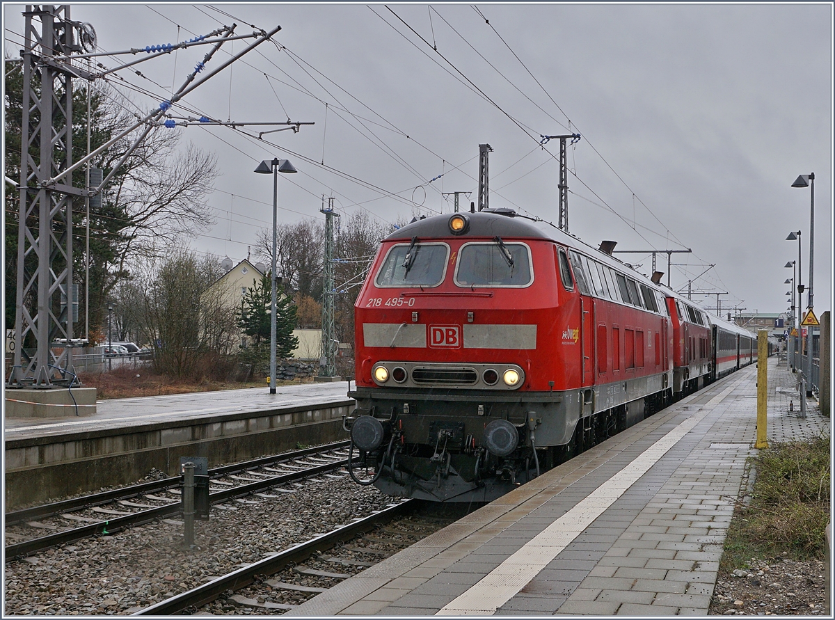 Die DB 218 495-0 und eine weitere mit ihrem IC 2012  Allgäu  Oberstdorf - Dortmund beim Halt im bereits elektrifizierten Bahnhof von Memmingen. 

15. März 2019