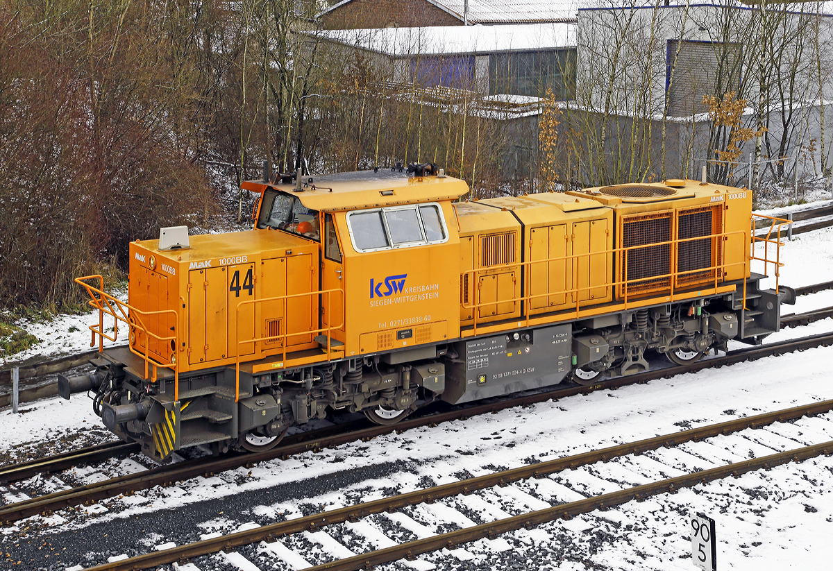 
Die Lok 44 (92 80 1271 004-4 D-KSW) der KSW (Kreisbahn Siegen-Wittgenstein), eine MaK G 1000 BB, rangiert am 30.01.2015 in Herdorf auf den KSW-Gleisen. 

Die Lok 44 wurde 2003 unter der Fabriknummer 1001462 bei Vossloh gebaut und am 05.01.2004 an die SK - Siegener Kreisbahn GmbH geliefert, welche ab Ende 2004 nun als Kreisbahn Siegen-Wittgenstein (KSW) firmiert.

Die G 1000 ist eine vierachsige dieselhydraulische Lokomotive
für den schweren Rangier- und leichten Streckendienst. Die zuverlässige Vielzwecklokomotive ist mit modernster Technik ausgestattet und erfüllt daher die neuesten Vorschriften des Unfallschutzes. Die Anwendungsbreite der Lokomotive reicht vom leichten Rangierdienst in Einzeltraktion über den Einsatz als Streckenlokomotive in Mehrfachtraktion bis hin zum schweren Rangierdienst. 

Mit der MaK G 1000 BB wird seit dem Jahr 2002 eine Lok für den Leistungsbereich unterhalb der G 1206 angeboten. Sie basiert auf der G 800 BB, von der außer dem kompletten Fahrwerk und Rahmen auch das Führerhaus und der hintere Vorbau übernommen wurden. Deutlich anders ist dagegen der vordere Vorbau, in dem Platz für den größeren Dieselmotor geschaffen wurde.


Technische Daten
Spurweite:  1435 mm
Achsfolge:  B´B´
Länge über Puffer: 14.130 mm
Drehzapfenabstand: 6.700 mm
Radsatzabstand im Drehgestell:  2.400 mm
größte Breite:  3.080 mm
größte Höhe über Schienenoberkante:  4.225 mm
Raddurchmesser neu:  1.000 mm
kleinster befahrbarer Gleisbogen:  60 m
Dienstgewicht: 80 t
Bremse:  Radscheibenbremse (Knorr), auf alle Räder wirkend
hydrodynamische Bremse
Bremsgewichte G/P: 65 t/96 t
Kraftstoffvorrat:  3000 l
    
Motor:  MTU 8V 4000 R41L
Leistung:  1.100 kW (1.475 PS)
Drehzahl:  1860 1/min
    
Strömungsgetriebe: Voith L4r4
Höchstgeschwindigkeit:  100 km/h
    
Seit 2002 wurden 103 G 1000 gebaut (Stand 01.01.2015).