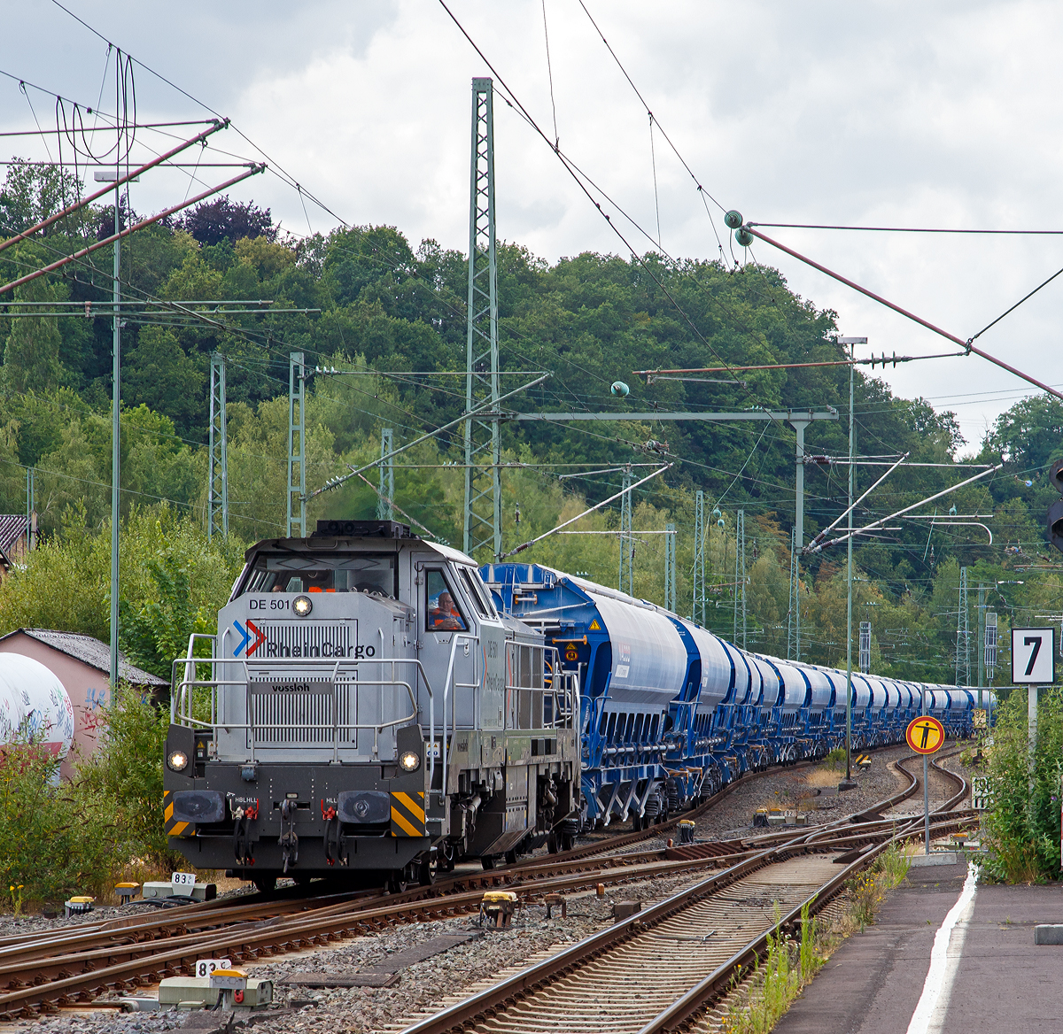 Die RHC DE 501 alias 4185 017-5 (92 80 4185 017-5 D-RHC) eine Vossloh DE 18  der RheinCargo fährt am Sonntag den 07.07.2019 mit einem Kalkzug (4-achsige Trichtermittenentladewagen der Gattung Tadns) durch Betzdorf/Sieg in Richtung Siegen.

Die dieselelektrische DE 18 wurde 2017 von Vossloh unter der Fabriknummer 5502235 gebaut.

TECHNISCHE DATEN:
Spurweite:  1.435 mm 
Achsfolge:  B‘B‘
Länge über Puffer : 17.000 mm  
Drehzapfenabstand: 7.940 mm
Achsabstand im Drehgestell: 2.400 mm
Raddurchmesser:  1.000 mm (neu) / 920 mm (abgenutzt)
Größte Höhe:  4.310 mm  
Größte Breite:  3.080 mm
Höchstgeschwindigkeit: 120 km/h
Dieselmotor:  MTU 12V 4000 R43(L) 
Dieselmotorleistung:  1.800 kW
Dieselmotordrehzahl  1.800 min-1
Abgasvorschriften:  EU/2004/26 Stufe IIIA/prepared for stage IIIB  
Anfahrzugkraft:  291 kN
Dienstgewicht:  90 t
Kraftstoffvorrat:  4.000 l
Stromrichter : IGBT
Elektrodynamische Bremsleistung: max. 1.440 kW 	
Kleinster befahrbarer Bogenradius:  55 m
