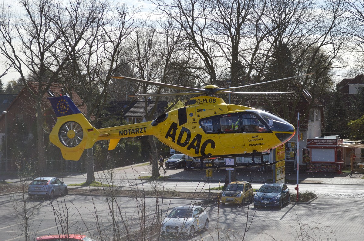 Ein ADAC Luftrettungs-Hubschrauber, ein Eurocopter EC-135 (D-HLGB)  Christoph 61  landet auf einem PKW-Parkplatz am S-Bhf. Berlin-Karow am 14.04.15