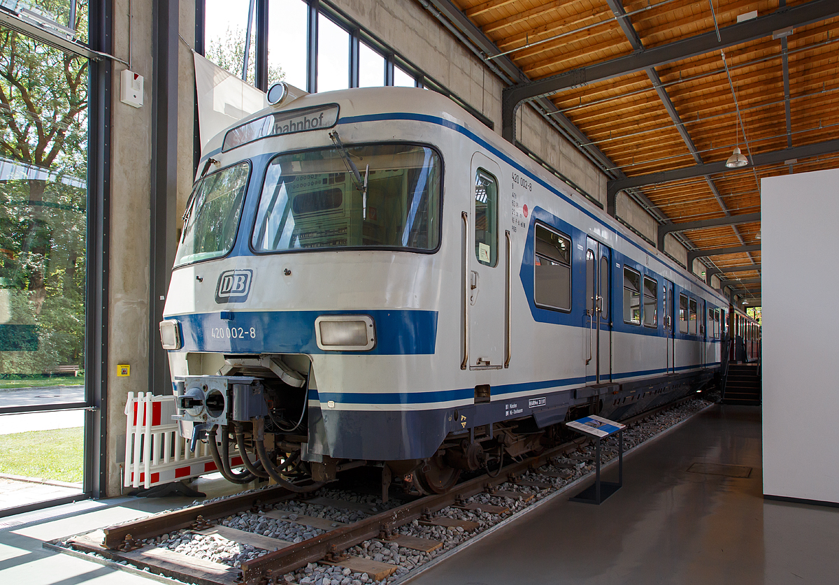 
Endtriebwagen ET 420 002-8 der Münchener S-Bahn (am 16.06.2018) ausgestellt im Verkehrszentrum des Deutschen Museums in München (Theresienhöhe).

Für die neu entstehenden S-Bahn-Systeme im Bereich der damaligen Deutschen Bundesbahn sollte Mitte der 60er Jahre des 20. Jahrhunderts ein Schnellbahnfahrzeug entwickelt werden, dass für die im Bau befindlichen Tunnelstrecken in München und Frankfurt geeignet war und darüber hinaus eine hohe Beschleunigung, stufenlosen Einstieg und viele Türen für einen schnellen Fahrgastfluß bieten sollte. In München wollte man sich verkehrstechnisch vor allem für das Großereignis der Sommerolympiade 1972 rüsten, daher wurden sie auch oft Olympiatriebwagen oder Olympiatriebzüge genannt.

Der ET 420 002 ist ein Endtriebwagen des zweiten Triebzuges der Vorausbauart der Münchener S-Bahn. Er wurde im Dezember 1969 zusammen mit zwei weiteren Prototypzügen in Betrieb genommen. Die dreiteiligen Triebzüge bestehen jeweils aus zwei Endtriebwagen und einem Mittelwagen. Untereinander mittels Kurzkupplungen miteinander verbunden, ergeben sie einen Kurzzug mit einer Gesamtlänge von 67 Metern. Ein Langzug, bestehend aus drei Kurzzügen, bietet Platz für 1200 Personen.

Solidität und Einsatztauglichkeit des Triebwagens führten dazu, dass die Bahn ihn in fast allen Ballungszentren der Bundesrepublik zum Einsatz brachte. Insgesamt wurden 480 Exemplare des „Olympiazuges“ gebaut, davon waren 210 im Betriebwerk München-Steinhausen stationiert. Als der ET 420 002 dem Deutschen Museum – Verkehrszentrum 2004 übergeben wurde, konnte eine Laufleistung von 3.479 Mio Kilometern festgehalten werden.

TECHNISCHE DATEN (kompl. Triebzug).
Länge über Kupplung: 67.400 mm 
Eigengewicht: 129 t 
Achsformel: Bo'Bo'+Bo'Bo'+Bo'Bo' (12 angetriebene Achsen über Tanzlagerantrieb). 
Dauerleistung: 2.400 kW(3.250 PS)
Höchstgeschwindigkeit: 120 km/h
Anfahrbeschleunigung: max. 1,0 m/s², im Betrieb 0,9 m/s²
Kupplungstyp:  Scharfenberg Typ 10
