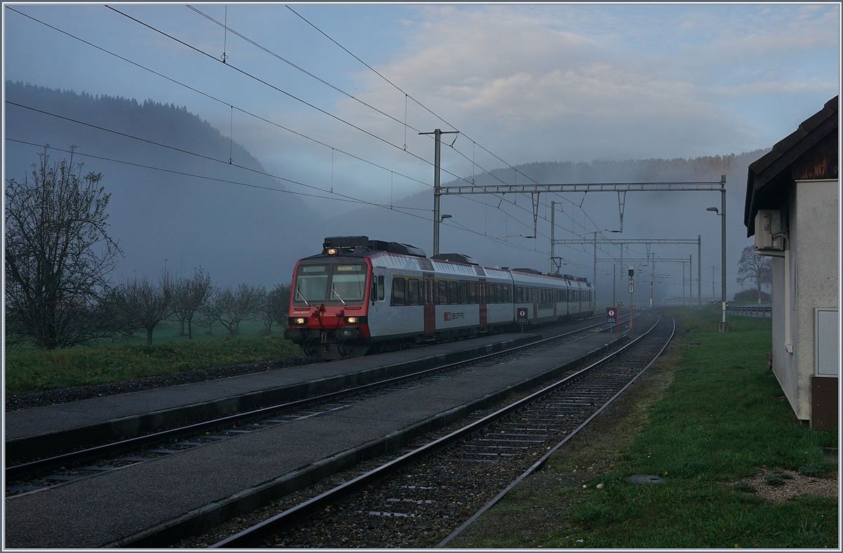 In der nebligen Morgendämmerung erreicht ein SBB RBDe 560 Pendelzug von Buttes nach Neuchâtel den Bahnhof Noiraigue. 

5. Nov. 2019
