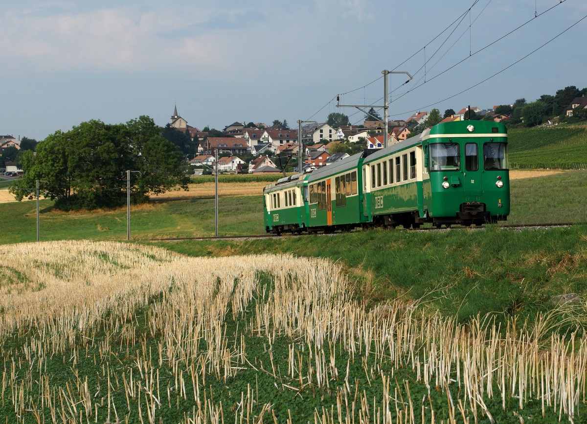 MBC/BAM: Regionalzug mit dem Bt 52 an der Zugsspitze vor der Kulisse der Waadtländer Gemeinde Yens mit ihren 1'150 Einwohnern. Die Aufnahme entstand am 13. August 2015 auf der Fahrt nach Bière.
Foto: Walter Ruetsch   