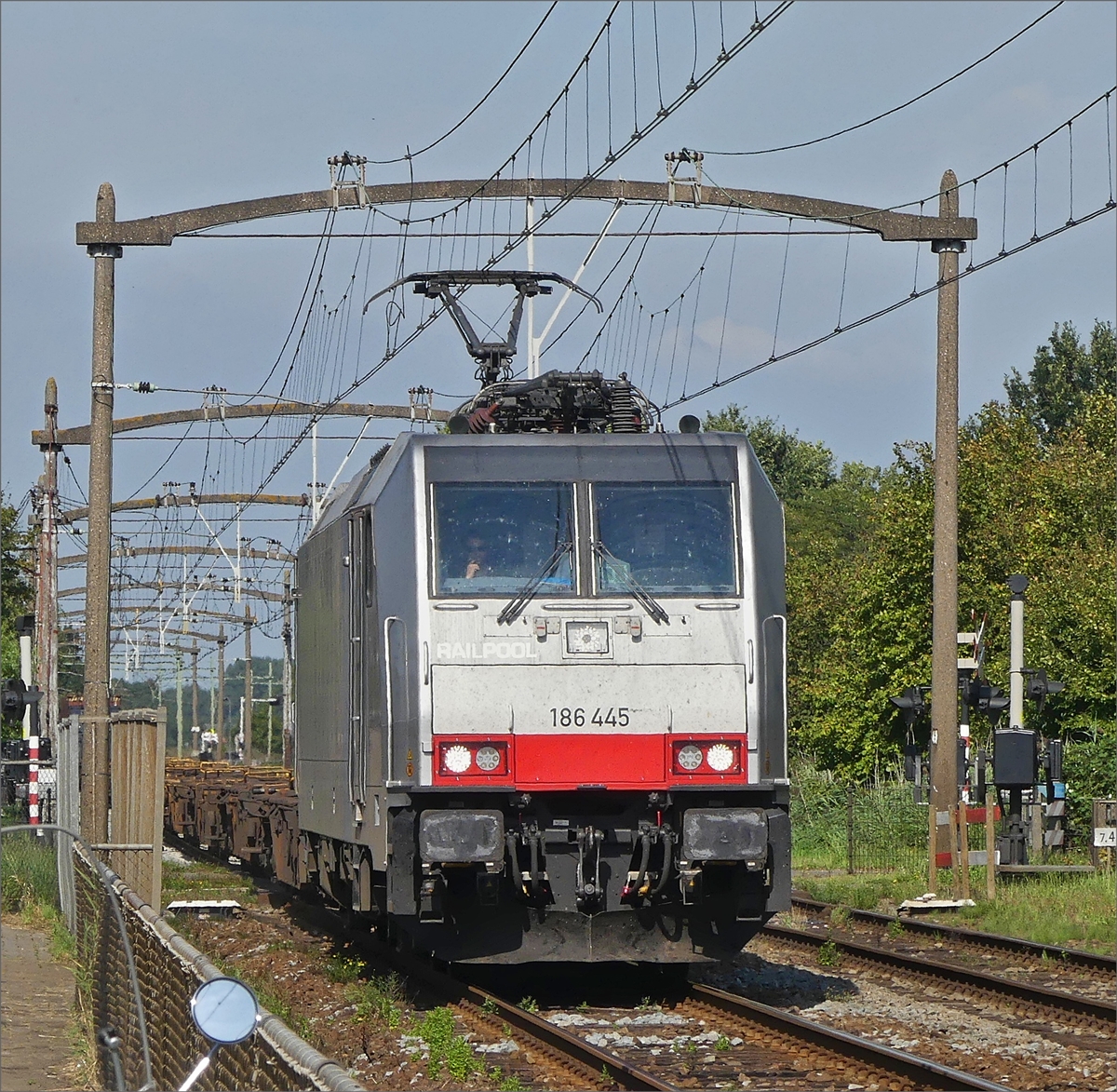 Raipool Lok 186 445 mit einem leeren Kontainergüterzug durchfährt am 30.08.2019 den Bahnhof von Zevenbergen.(Jeanny)