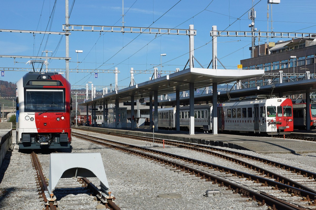 TPF: Der neue dreiteilige Pendelzug von Stadler Rail bestehend aus ABe 2/4 + B + ABe 2/4 und ein dreiteiliger Pendelzug mit dem BDe 4/4 124 (1996) in Bulle am 12. November 2015. Mit den neuen Z�gen werden die Be  4/4 151 - 152 und die BDe 4/4 141 - 142 abgel�st. Die BDe 4/4 werden zur Zeit auch noch im Rollbockverkehr zwischen Bulle und Broc eingesetzt.
Foto: Walter Ruetsch