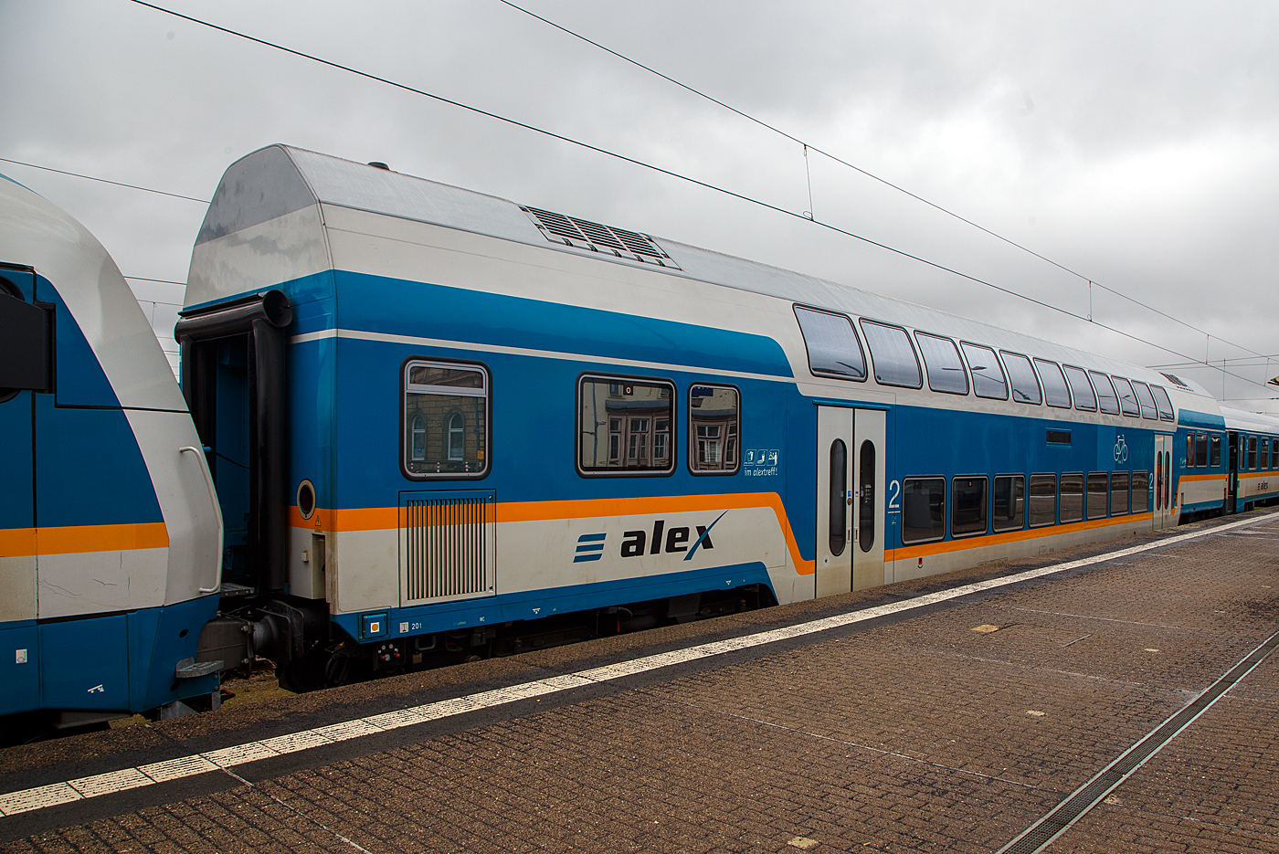 Der „alex“ zweite Klasse Doppelstockwagen der Bauart DBpz, D-DBL 56 80 26-75 602-0, der DBL - Die Länderbahn GmbH, eingereiht in einen RE nach München Hbf, am 17 April 2023 im Hbf Hof.

Sieben dieser klimatisierten Doppelstockwagen wurden 2009 bei Bombardier beschafft um der Wachsenden Nachfrage auf dem Nordast gerecht zu werden.

TECHNISCHE DATEN:
Hersteller: Bombardier, Werk Görlitz
Baujahr: 2009
Spurweite: 1.435 mm (Normalspur)
Länge über Puffer: 26.800 mm
Wagenkastenlänge: 26.400 mm
Drehzapfenabstand: 20.000 mm
Achsstand im Drehgestell: 2.500 mm
Drehgestellbauart: Görlitz VIII
Leergewicht: 50 t
Höchstgeschwindigkeit: 160 km/h
Zulassungen für: D
Sitzplätze: 126 in der 2. Klasse
Bremsbauart: KE-PR-A-Mg
