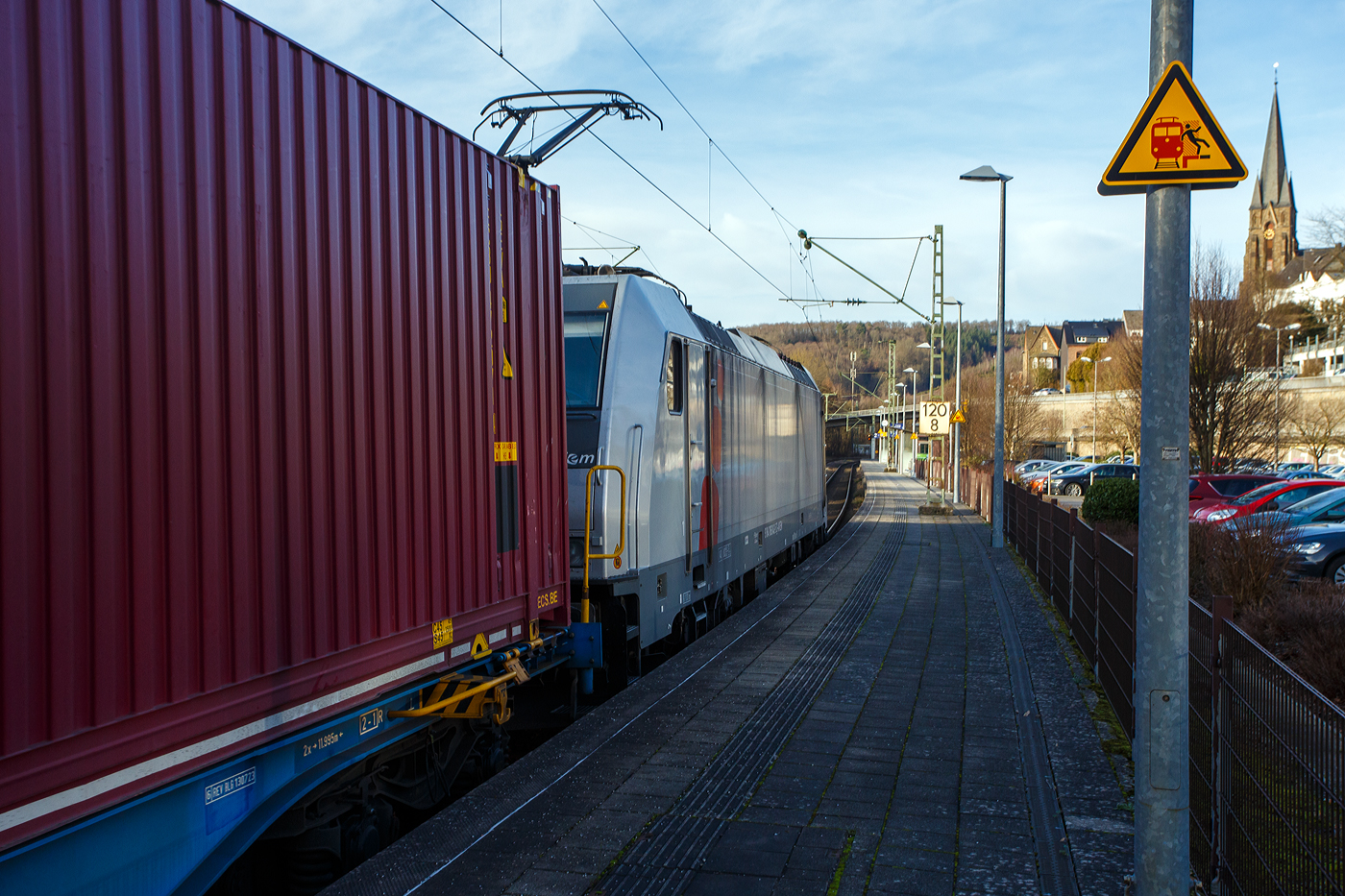 Die an die LINEAS Group NV/SA vermietete E 186 042 (91 84 1186 042-5 NL-AKIEM, angeschrieben ist D- AKIEM, was aber nach der Nummer falsch ist) fährt am 16. Dezember 2025 mit einem Containerzug durch den Bahnhof Kirchen/Sieg in Richtung Siegen.

Die Bombardier TRAXX F140 MS(2E) wurde 2016 von Bombardier in Kassel unter der Fabriknummer 35358 gebaut und an die NS - Nederlandse Spoorwegen N.V., als 91 84 1186 042-5 NL-NS geliefert. Bereits im Juni 2018 wurde sie an die AKIEM SAS verkauf und von der NS wieder angemietet. Nun seit 2025 ist sie an die LINEAS Group vermietet. Die Multisystemlokomotive hat die Zulassungen bzw. besitzt die Länderpakete für Deutschland, Österreich, Belgien und die Niederland (D/A/ B/NL).