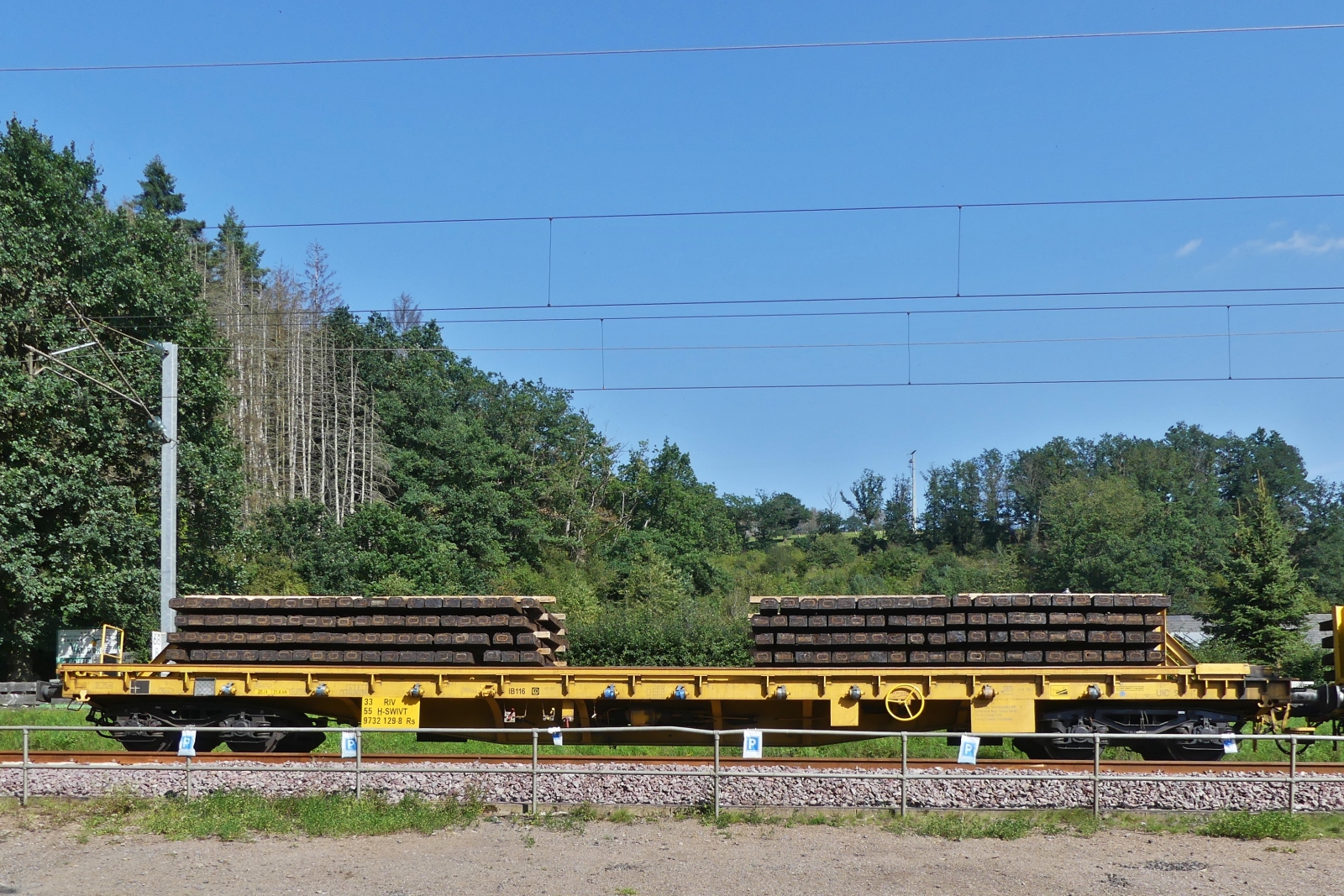 Flachgüterwagen der Reihe RS, (H-SWIVT 9732 129-8) beladen mit alten Holz Schwellen, im Gleisbauzug bei Enscherange eingereiht. 23.08.2023