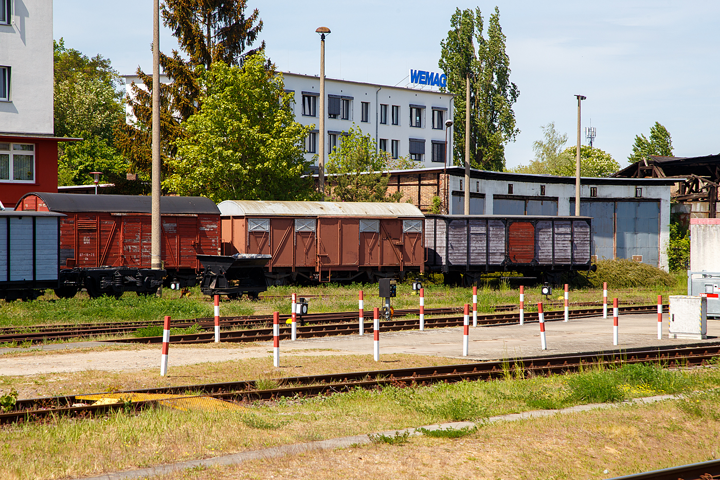 Gleich neben dem Hauptbahnhof ist das einstige Bahnbetriebswerk hier ist heute das Mecklenburgisches Eisenbahn- und Technikmuseum der MEF - Mecklenburgische Eisenbahnfreunde Schwerin e.V., leider gab es hier im Sommer 2023 einen Gro�brand. Hier am 16. Mai 2022 stehen, vorne eine Feldbahn-Kipplore, dahinter von links nach rechts:

Der zweiachsige gedeckte G�terwagen der Bauart Oppeln mit Bremserhaus, ex DR 07-15-75, der Gattung Gs. 
TECHNISCHE DATEN:
Baujahr:  ab 1938
Spurweite:  1.435 mm (Normalspur)
Gattung: Gs
Achsanzahl: 2
L�nge �ber Puffer:  9.800 mm
Achsanstand: 6.000 mm
Eigengewicht: 10.330 kg
Ladegewicht: 15.000 kg
H�chstgeschwindigkeit: 90 km/h
Ladefl�che:  21,2 m�

Der zweiachsige gedeckte G�terwagen 162 899 der Gattung Gmms 60.
TECHNISCHE DATEN:
Baujahr:  1965
Spurweite:  1.435 mm (Normalspur)
Gattung: Gmms 60
Achsanzahl: 2
L�nge �ber Puffer:  10.600 mm
Achsanstand: 5.700 mm
Eigengewicht: 11.050 kg
Ladegewicht: 31.500 kg
H�chstgeschwindigkeit: 100 km/h
Ladefl�che:  25 m�

Der zweiachsige gedeckte G�terwagen 04-41-34 der Gattung G der Gro�herzoglich Mecklenburgische Friedrich-Franz-Eisenbahn (M.F.F.E.), ab 1920 Deutsche Reichseisenbahnen (DR).
TECHNISCHE DATEN:
Baujahr:  ab 1910
Spurweite:  1.435 mm (Normalspur)
Gattung: G
Achsanzahl: 2
L�nge �ber Puffer:  9.300 mm
Achsanstand: 4.500 mm
Eigengewicht: 9.400 kg
Ladegewicht: 15.000 kg
H�chstgeschwindigkeit: 60 km/h
Ladefl�che:  21,3 m�