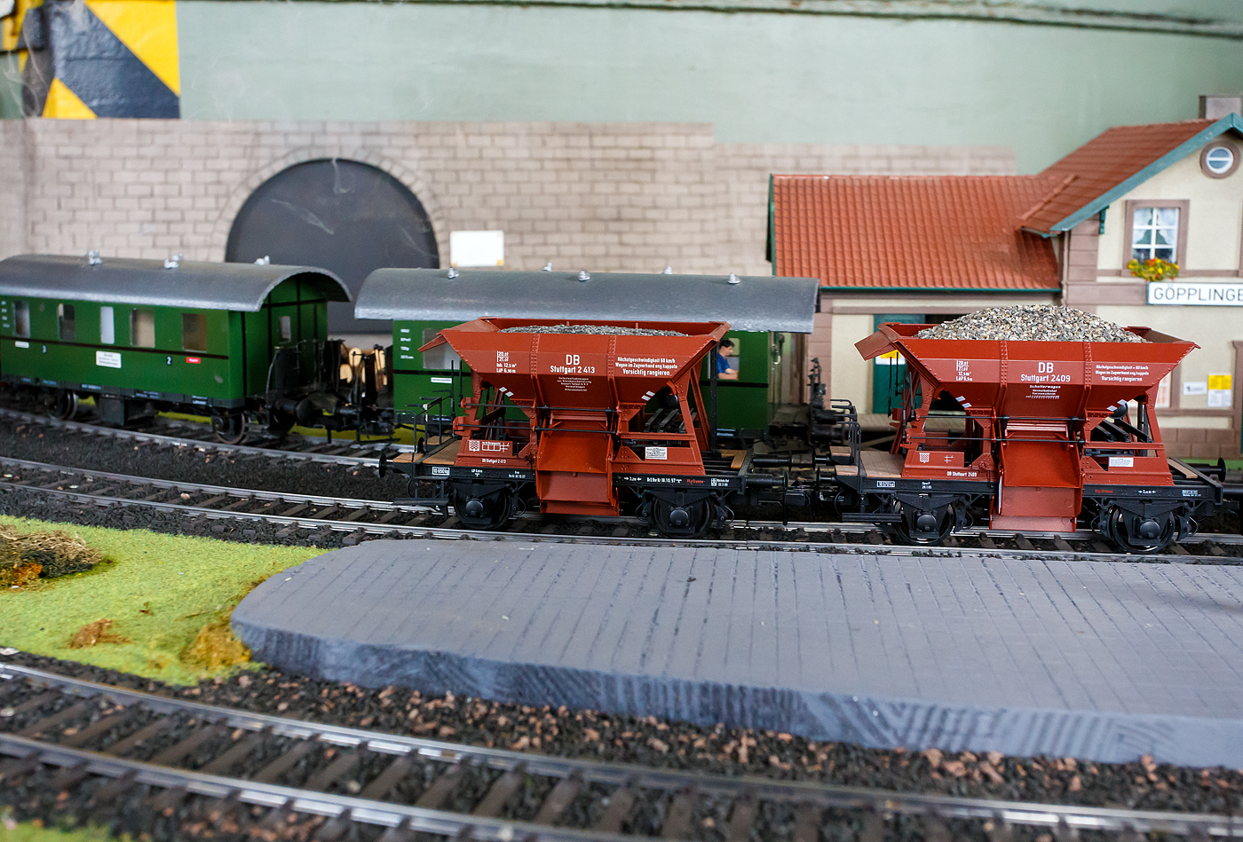 Lokschuppenfest der WEF - Westerwälder Eisenbahnfreunde 44 508 e. V. am 07 Juli 2024 in Westerburg. Im Lokschuppen gibt es eine Spur 1-Modelbahnanlage um einen Kohlekran herum. Hier die beiden Spur 1-Modelle (Maßstab 1:32), die Talbot-Schotterwagen DB Stuttgart 2413 und 2409 (Trichterwagen mit dosierbarer Entladung, der Gattung Ot Mainz), beim Bahnhof Göpplingen (Fantasienamen von PIKO).

Einer der interessantesten und meist gebauten Vertreter der Selbstentladewagen war der zweiachsige von Talbot entwickelte 20 t-Schotterwagen mit Lenkachsen und einem Ladevolumen von 12,5m³. Er wurde auch als Trichterwagen bezeichnet und wurde in ähnlichen Ausführungen von mehreren Waggonfabriken in großen Stückzahlen gebaut. Als bahneigenes Dienstfahrzeug kam er vornehmlich beim Streckenbau zum Einsatz. Für dieses überaus erfolgreiche Fahrzeug wurde bald das Synonym  Talbotwagen  geprägt. Durch je drei einzeln verstellbare Schütten auf jeder Fahrzeugseite konnte der Schotter sowohl innerhalb als auch außerhalb der Gleise sehr genau platziert werden. 
Diejenigen zweiachsigen Schotterwagen, die nicht als Bahndienstfahrzeug Verwendung fanden, wurden dem Gattungsbezirk Mainz zugeordnet.

TECHNISCHE DATEN der Originale:
Spurweite: 1.435 mm (Normalspur)
Achsanzahl: 2
Länge über Puffer: 6.900 mm
Achsabstand: 3.200 mm
Eigengewicht: ca. 10.500 kg
Ladevolumen: 12,5 m³
Ladegewicht: 20.000 kg (Tragfähigkeit 21.000 kg)
Gattungsbezeichnungen: DRG = Otmn Mainz, DR (Ost) = Otmn 45, DB = Ot 03, Otm 07 oder Otmn 36