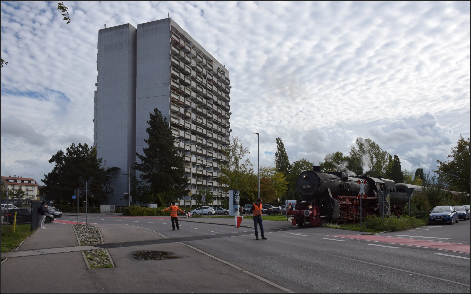 Schienenverkehr unterm Hohentwiel. 

52 7596 mit ihrem EFZ-Sonderzug für die SEHR & RS beginnt die Bahnübergangsralley in Singen in der Worblinger Strasse. Oktober 2022.
