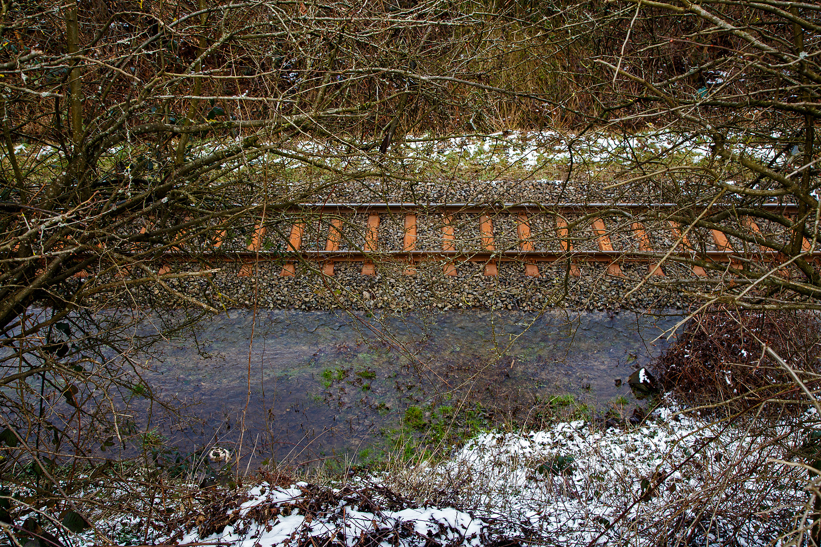 Schlimmer geht immer.....
Totalsperrung der Hellertalbahn (KBS 462 / Strecke 2651)
Nun ist Herdorf Bahntechnisch zur Insel geworden. 
Es gibt seit dem 10.03.23 eine Gleisuntersp�lung auf der Strecke 2651 bei km 91,0, so ist vorerst auch kein G�terverkehr von Haiger nach Herdorf m�glich. Da die Strecke Betzdorf – Herdorf, bereits wegen dem Felsstutz  am 23.12.2022, seitdem gesperrt ist Herdorf nun Bahntechnisch ganz abgeschnitten. 

Hier sieht man wie viel Wasser auf dieser Seite vom Gleis flie�t (was man leider auf einem Foto nicht so sehen kann). Das Wasser suchte sich aber seinen Weg unter dem Gleis hindurch auf die andere Seite. Optisch konnte ich aber keinen gro�en Schaden am Gleisbett selbst sehen, aber wenn so viel Wasser hindurch gelaufen ist wird es wohl weich sein. 