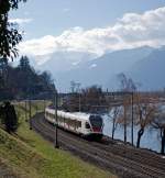 Stadler FLIRT  RABe 523 024 der SBB (RER Vaudois) als S1 (Villeneuve - Montreux -  Vevey - Lausanne -  Yverdon-les-Bains),f�hrt am 26.02.2012 bei  Clos du Moulin am Genfersee Richtung Lausanne.